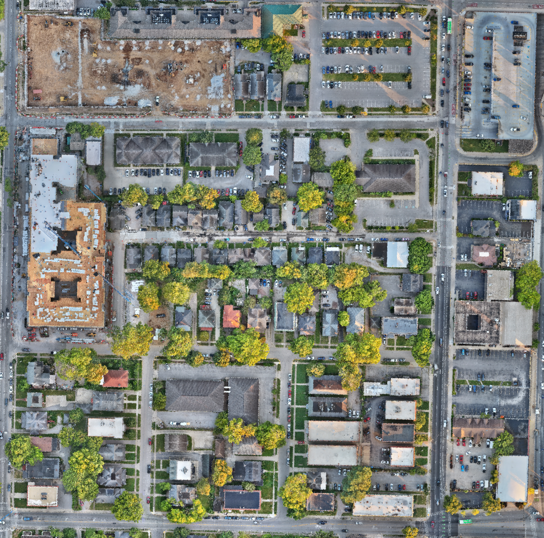 Detailed orthophoto showing buildings, roads, parking, and active construction